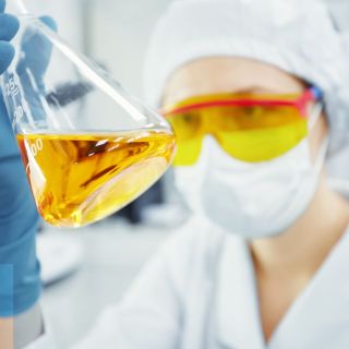 close-up-portrait-young-woman-s-hands-holding-test-tube-with-yellow-liquid