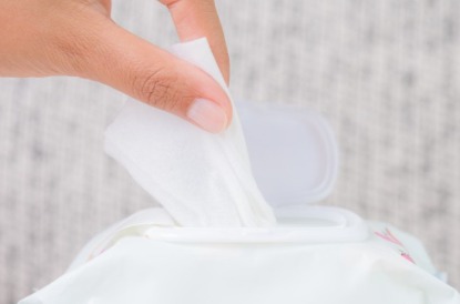 closeup-woman-hand-holding-wet-wipes-from-package